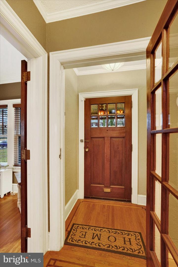 Foyer at 185 Peyton Road showing original Craftsman front door with divided-light glass and hardwood floors