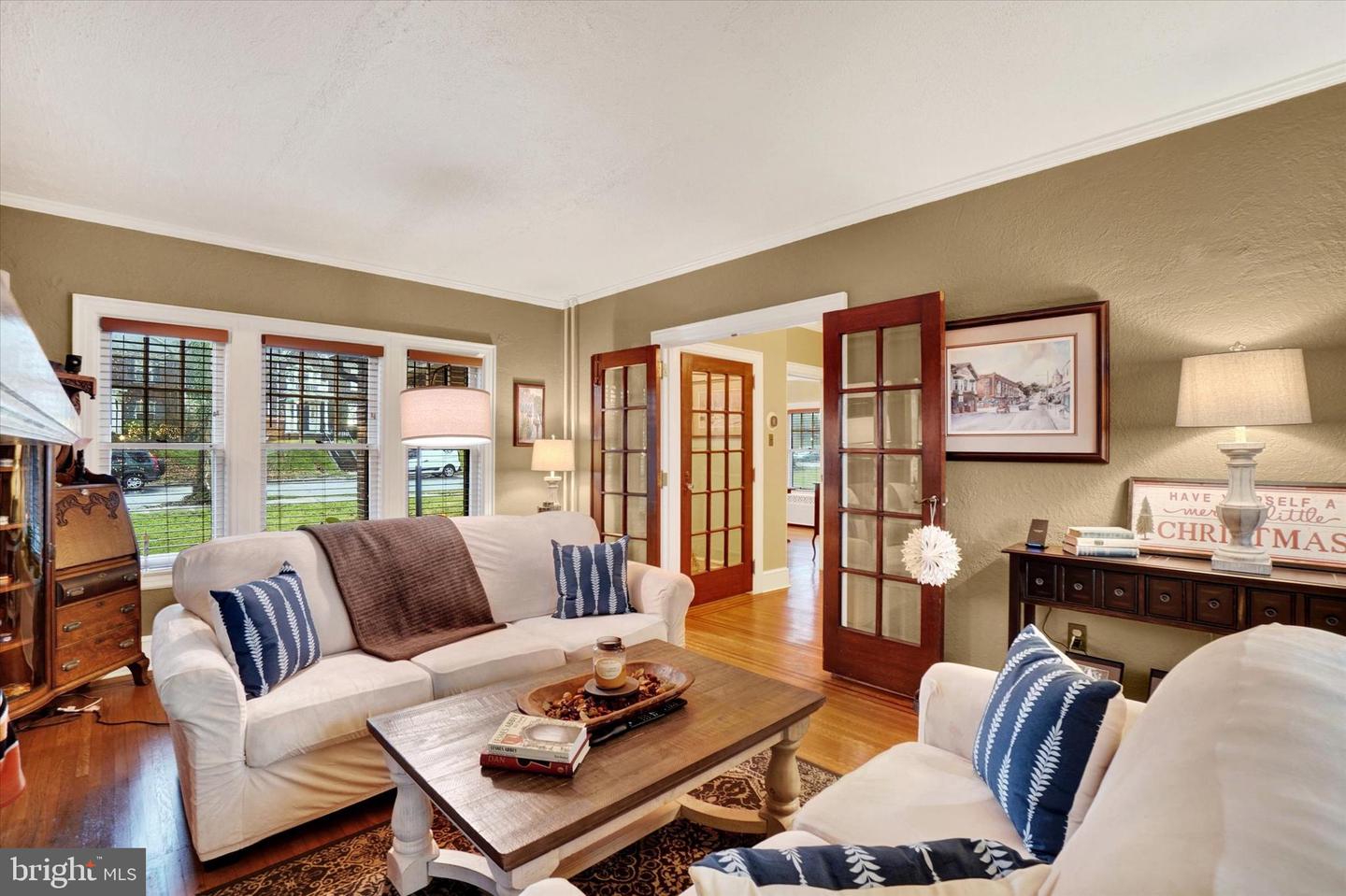 Living room at 185 Peyton Road looking toward foyer, showing French doors with divided-light glass