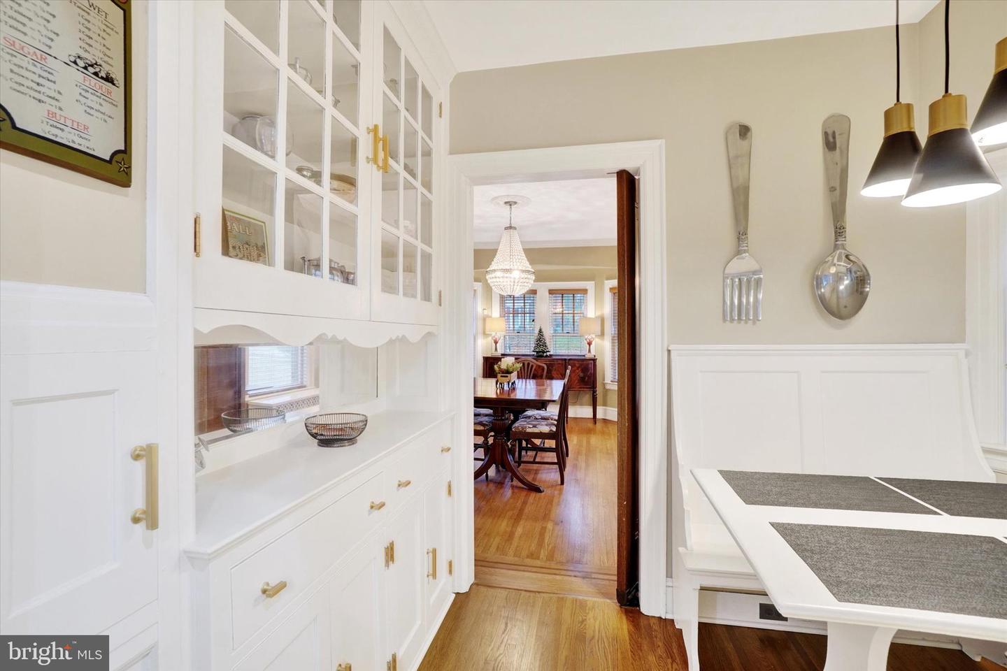 Butler's pantry at 185 Peyton Road with original built-in glass-front cabinets and wainscoting, looking toward dining room