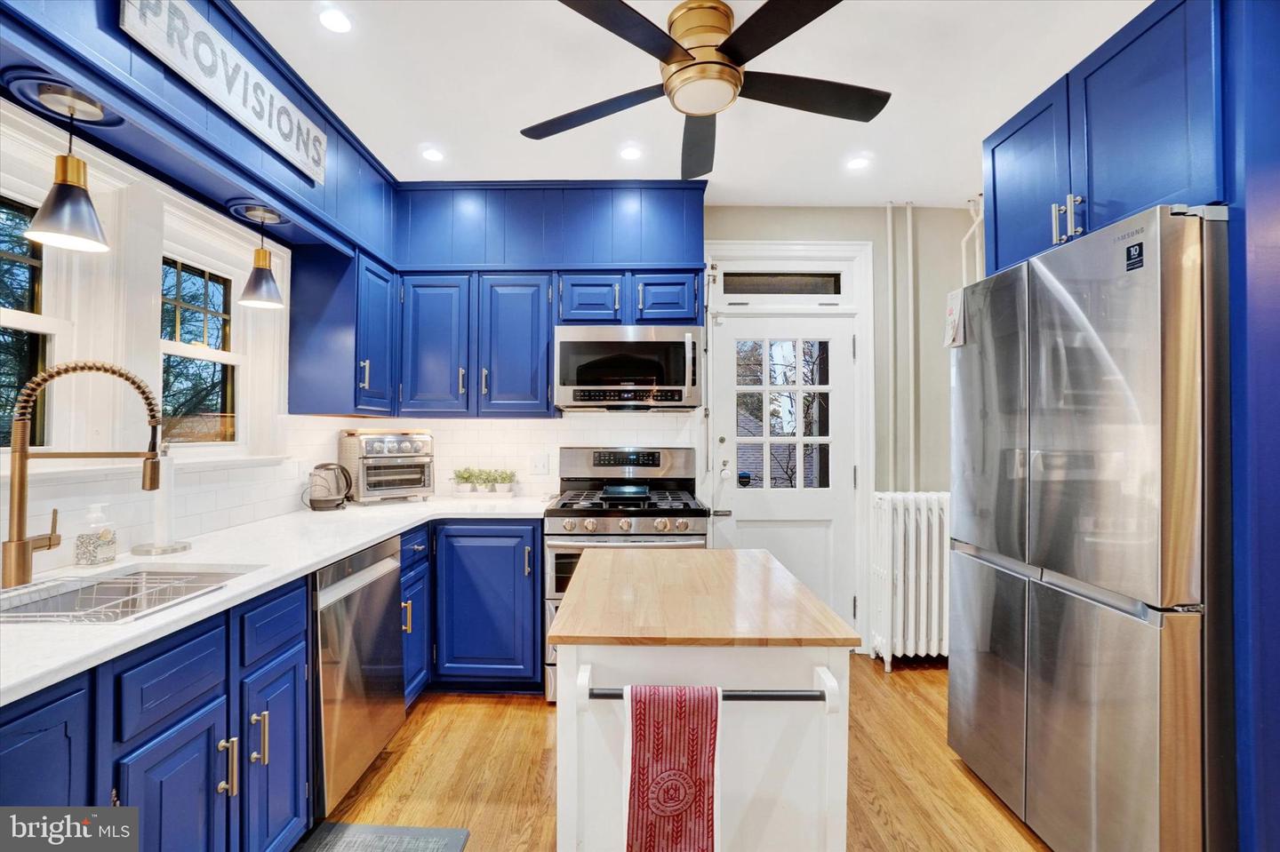 Kitchen at 185 Peyton Road showing blue cabinets, gas range, and gold hardware