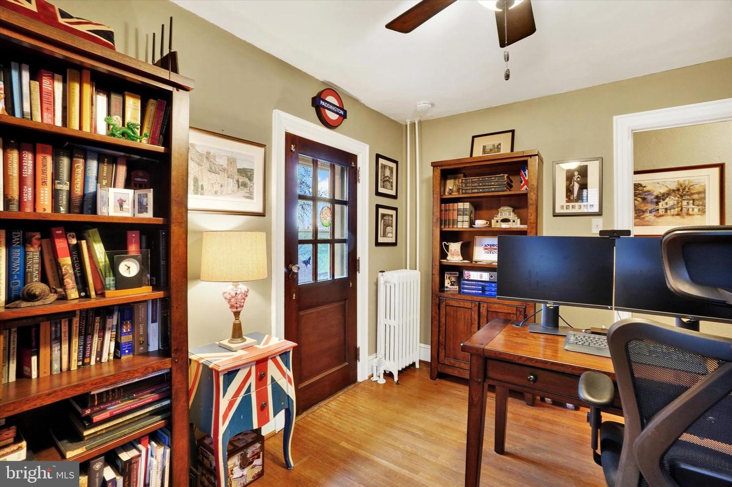 Study at 185 Peyton Road showing bookshelves, glass-pane door to porch, and original radiator