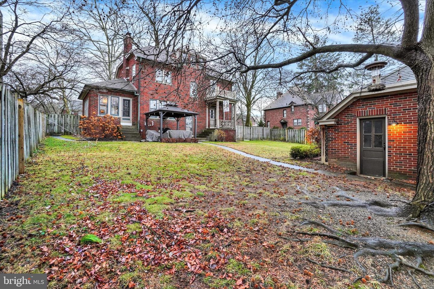 Full backyard view of 185 Peyton Road showing yard, outbuilding, and neighboring homes